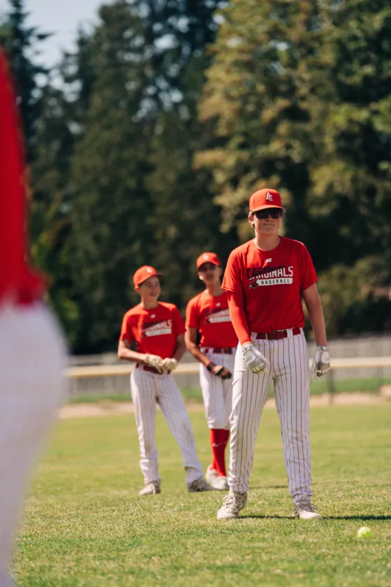 The Abbotsford Cardinals squad gathered in red on the outfield grass.