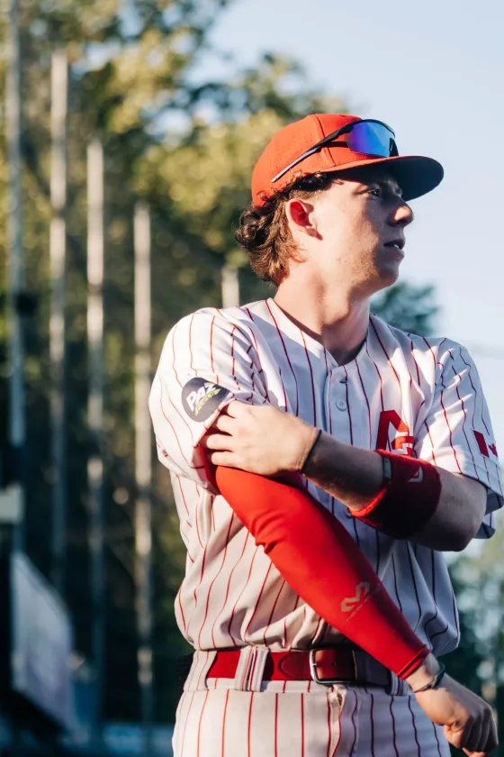 An Abbotsford Cardinals player pulling his jersey sleeve down, a close detail shot.