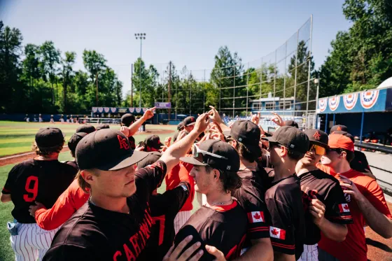Abbotsford Cardinals players high-five through a tunnel of raised arms.