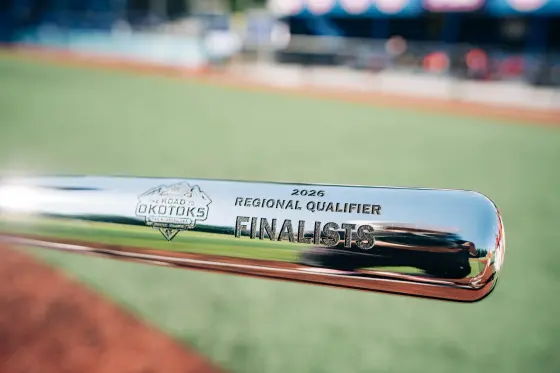 A chrome trophy bat engraved The Road to Okotoks, 2026 Regional Qualifier, Finalists.